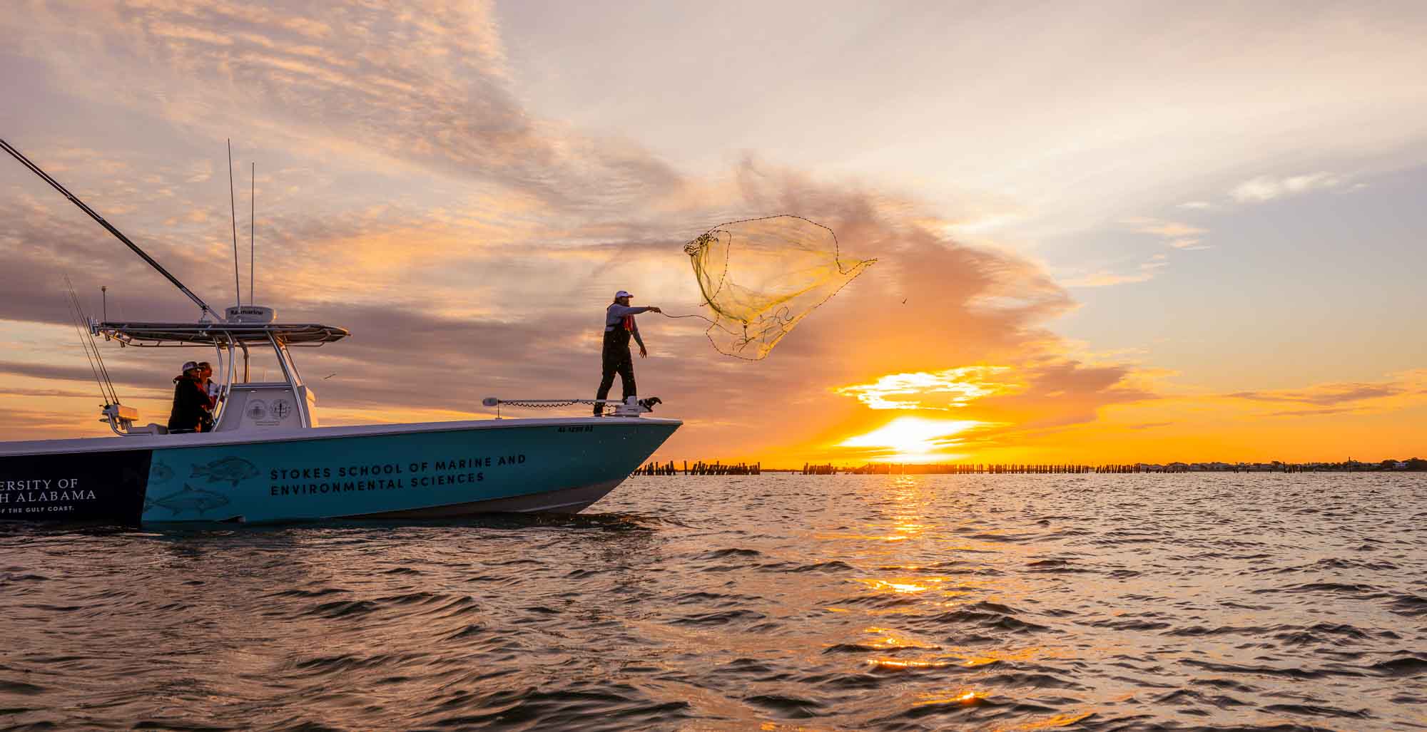 Someone casting a net on Mobile Bay