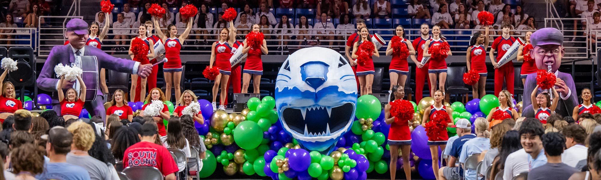 Mardi Gras themed convocation stage with cheerleaders