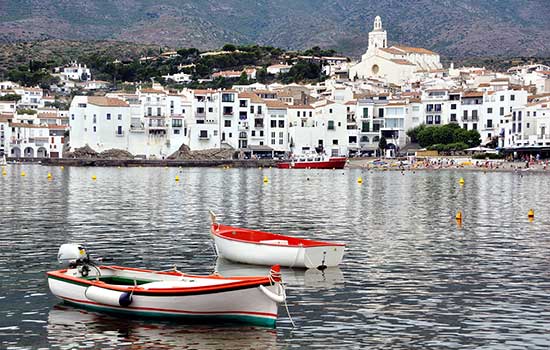 Spanish coast with lake and boats.