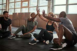 People highfiving after a workout class.
