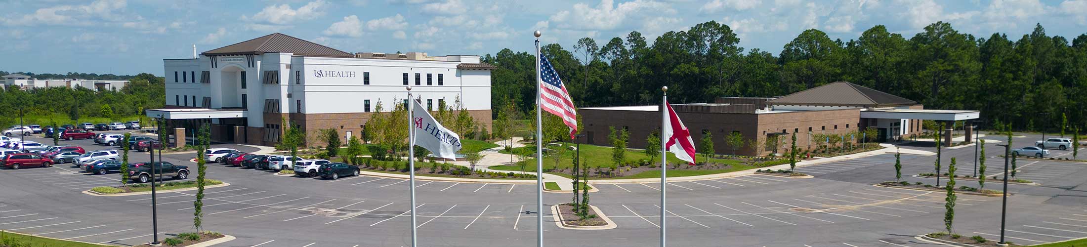 USA Health facility with flags in front.