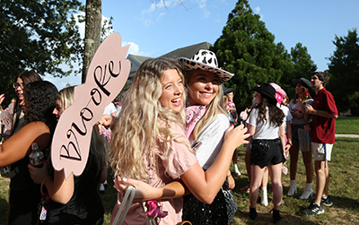 Two sorority girls hugging on bid day.