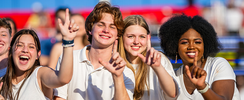 Students holding up J hand for Jaguars.