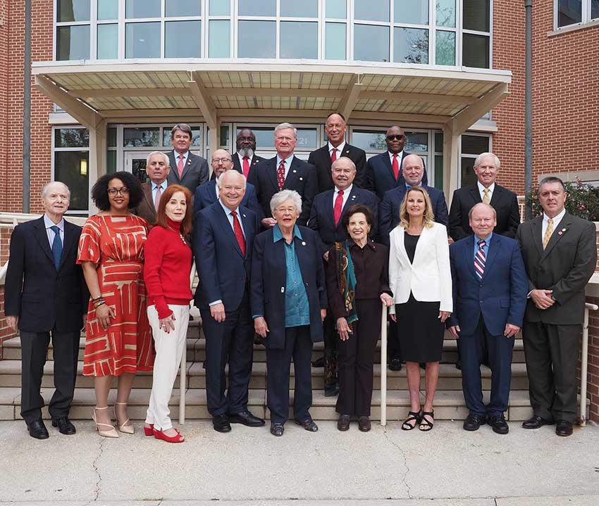 P​i​ctured from the left:  Honorary Trustee Abe Mitchell with Trustees Dr. Steve Furr; Dr. Scott Charlton; Ron Jenkins; Chandra Brown Stewart; Jimmy Shumock; Jim Yance; Ken Simon - Chair pro tempore; Ron Graham; Governor Kay Ivey - ex officio President and Chair​; Dr. Steve Stokes; Tom Corcoran; Lenus Perkins; Arlene Mitchell; Mike Windom; Alexis Atkins and Margie Tuckson; and President Tony Waldrop.